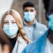 Authentic shot of multiracial people in the city wearing face mask and walking on the pavement commuting to work - Lifestyle and health issues concepts