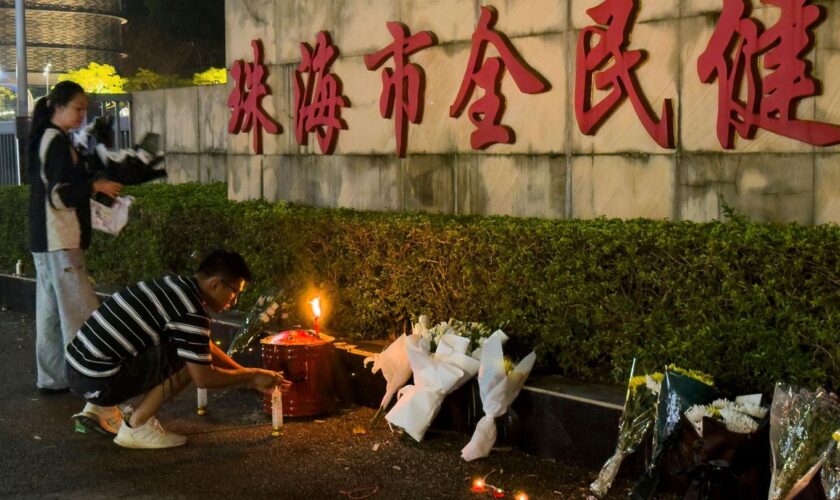 Ein Mann zündet eine Kerze vor dem "Zhuhai People's Fitness Plaza" in China an. Hier war der Mann mit seinem Auto absichtlich in eine Menschenmenge gerast. (Archivbild)