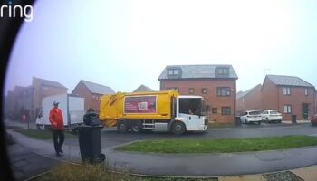 Moment binman removes rubbish bag from top of bin and dumps it on ground in Christmas collection