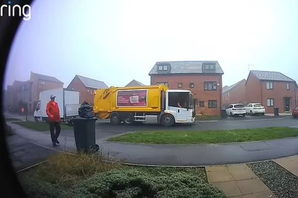 Moment binman removes rubbish bag from top of bin and dumps it on ground in Christmas collection