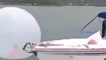 Moment boy rescued after being found floating in bubble in the middle of the sea