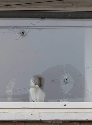 Photos show home's window riddled with bullet holes after 'gunman on bike' opens fire