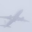 A plane takes off in misty conditions from London Gatwick airport on Saturday. Pic: PA