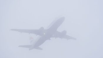 A plane takes off in misty conditions from London Gatwick airport on Saturday. Pic: PA