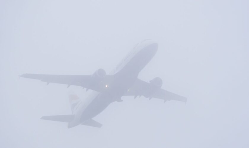 A plane takes off in misty conditions from London Gatwick airport on Saturday. Pic: PA