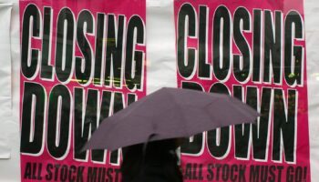 A woman walks by a shop advertising its closure in Croydon, south London, Friday, Jan. 23, 2009. The British economy has officially sunk into recession, with government figures Friday showing the economy shrank 1.5 percent in the fourth quarter of last year as the financial crisis ravaged banks, retail and manufacturing. It was the biggest decline since the early days of Margaret Thatcher's government nearly 30 years ago. (AP Photo/Sang Tan)