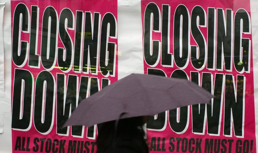 A woman walks by a shop advertising its closure in Croydon, south London, Friday, Jan. 23, 2009. The British economy has officially sunk into recession, with government figures Friday showing the economy shrank 1.5 percent in the fourth quarter of last year as the financial crisis ravaged banks, retail and manufacturing. It was the biggest decline since the early days of Margaret Thatcher's government nearly 30 years ago. (AP Photo/Sang Tan)