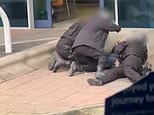 Moment police at Manchester Airport 'kick and punch' man as he is pinned to the ground during arrest