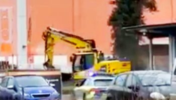 Stolen digger goes on rampage down street as armed police swarm vehicle