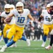 Justin Herbert of the Los Angeles Chargers runs with the football