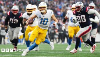 Justin Herbert of the Los Angeles Chargers runs with the football