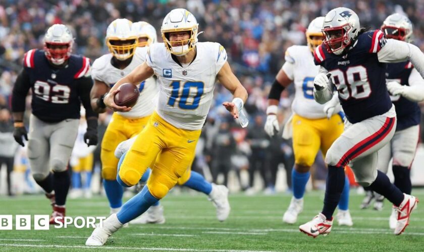 Justin Herbert of the Los Angeles Chargers runs with the football