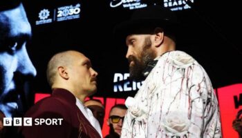 Tyson Fury, with an intense look in his eye, stares at Oleksandr Usuk