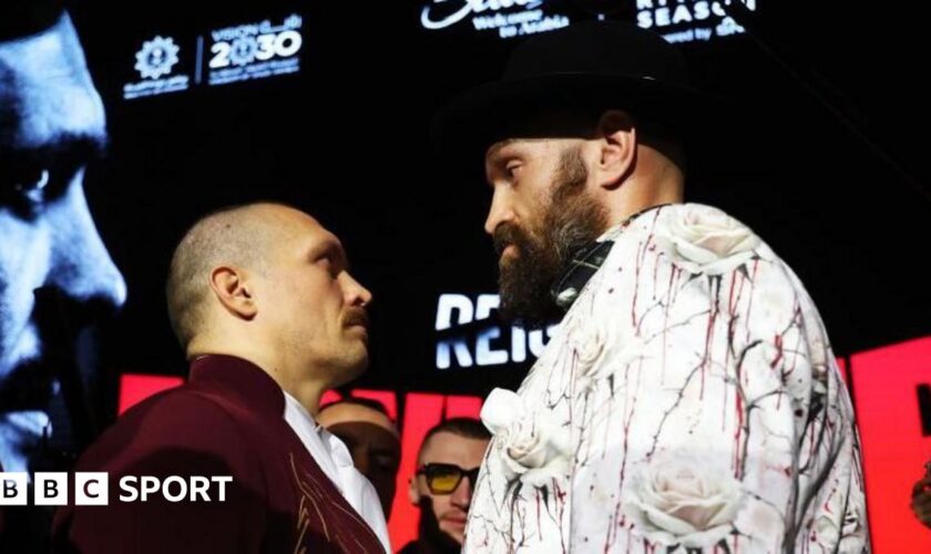 Tyson Fury, with an intense look in his eye, stares at Oleksandr Usuk