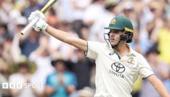 Sam Konstas raising his bat after hitting a half-century