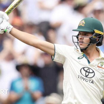 Sam Konstas raising his bat after hitting a half-century