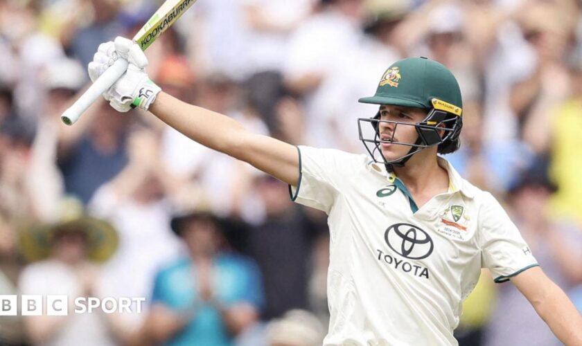 Sam Konstas raising his bat after hitting a half-century