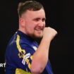 Luke Littler celebrates winning a leg against Ian White in the third round of the PDC World Darts Championship