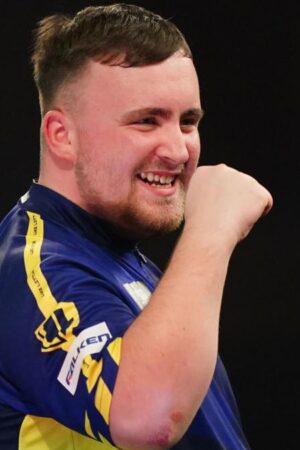 Luke Littler celebrates winning a leg against Ian White in the third round of the PDC World Darts Championship