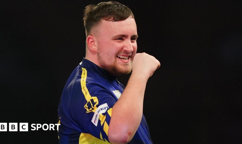 Luke Littler celebrates winning a leg against Ian White in the third round of the PDC World Darts Championship