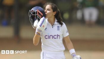 England's Maia Bouchier kisses the badge on her helmet after reaching a century on her Test debut against South Africa