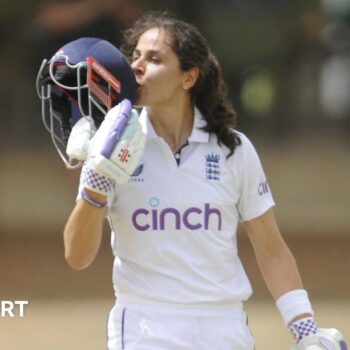 England's Maia Bouchier kisses the badge on her helmet after reaching a century on her Test debut against South Africa