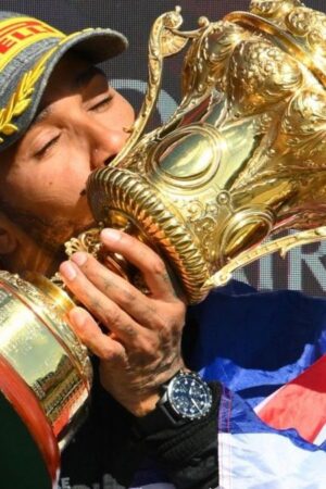 Lewis Hamilton kisses the trophy after winning the British Grand Prix