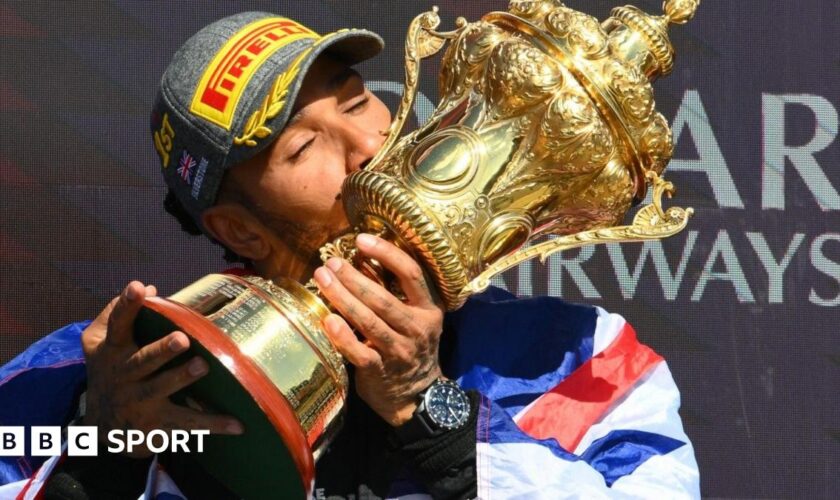 Lewis Hamilton kisses the trophy after winning the British Grand Prix