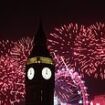 Hardy Brits ignore gale warnings and torrential downpours to see in the New Year in style - as traditional fireworks light up Big Ben in spite of storm fears that forced many displays to be axed