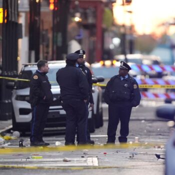 Emergency services attend the scene on Bourbon Street after a vehicle drove into a crowd on New Orleans' Canal and Bourbon Street, Wednesday Jan. 1, 2025. (AP Photo/Gerald Herbert)